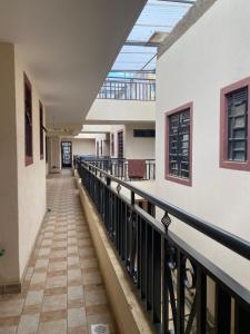 a corridor of a building with a balcony at Lucky House in Nanyuki