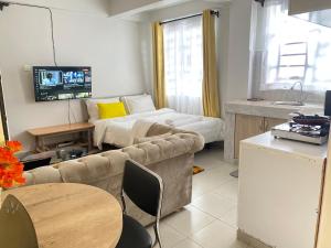 a living room with a couch and a bed at Lucky House in Nanyuki