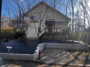 a white house with a porch and a driveway at リサの家 in Nasu-yumoto