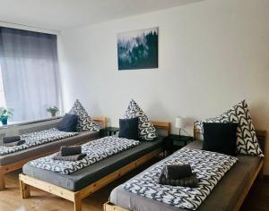 a room with three beds with pillows on them at Premium Home 1 in Busingen am Hochrhein