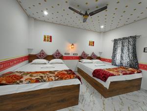 a bedroom with two beds and a ceiling at sundarbon birds view cottage in Japur +22 photos