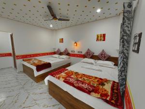 a bedroom with two beds and a ceiling at sundarbon birds view cottage in Japur