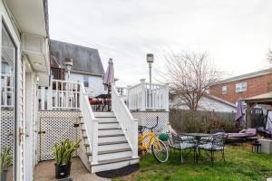 a staircase leading to a house with a table and chairs at Bella room near downtown Train I-95 & beaches in Stamford