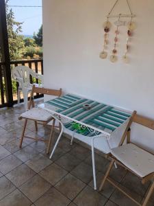 a table and chairs on a patio with a view at "STARDUST" Family House in Metamorfosi