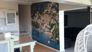 a room with a wall with a painting on it at Villa Lucca in Cape Town