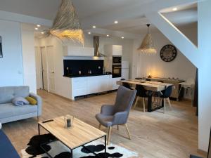 a living room with a couch and a table at Family Appart 2 in Le Tréport