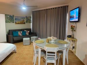 a living room with a table and chairs and a couch at Confortable vista al mar in Juan Dolio