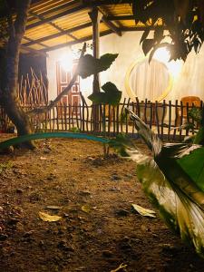 a group of chairs and a table and a fence at Dana's Villa in Ahangama