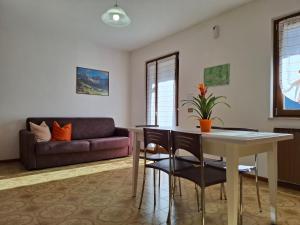 a living room with a table and a couch at Residence ai Tovi in Ledro