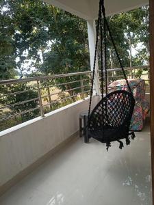 a swing on the porch of a house at Luxury Bonafide Villa in Lohārghāt +1 photo