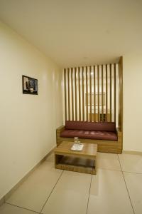 a room with a bed with a table in it at Grand View Residency in Nīleshwar