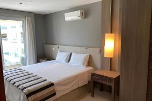 a hotel room with a bed and a window at Brisas do Lago - Apartamento 7 in Brasilia +29 photos