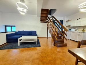 a living room with a blue couch and a table at Villa Viva-Como in Domaso