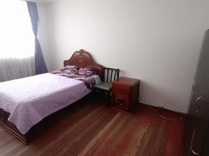 a small bedroom with a bed and a dresser at Habitacion amplia SOLO PARA MUJERES en lindo apto in Pasto