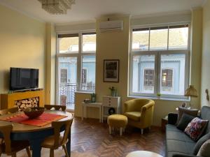 a living room with a couch and a table at Ergzotic Apartments & Room in Sombor