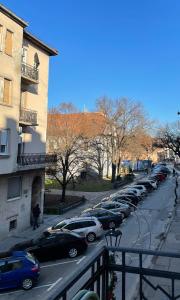 a row of cars parked on a city street at Ergzotic Apartments & Room in Sombor