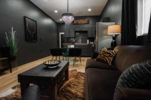 a living room with a couch and a table at Speakeasy Suite at ArnoTriplex-Close to Downtown-Pet Friendly! in Albuquerque