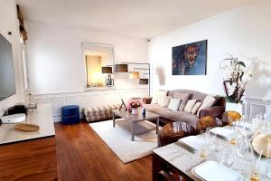 una sala de estar con un sofá y una mesa en Le Terranova - Maison hypercentre, en Deauville 30 fotos más