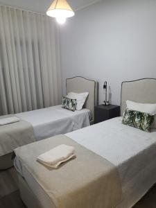a room with two beds with towels on them at Beira Mar Loft in Aveiro +69 photos
