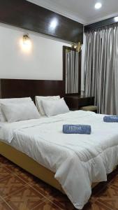 a hotel room with a large bed with a blue robe on it at Jev Penthouse in Port Dickson +17 photos