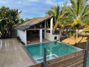 a house with a swimming pool next to a building at Le ZANATANY BEACH in Tamatave