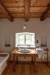 a bathroom with a sink and a window at The Bat Barn in Kelevíz