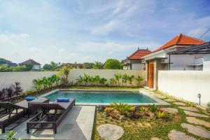 a swimming pool in the backyard of a house at Puri Arta Villa in Ubud