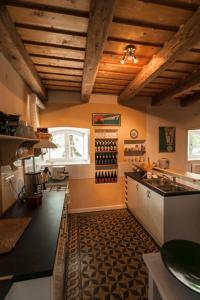 a kitchen with a counter and a window with wine bottles at The Bat Barn in Kelevíz