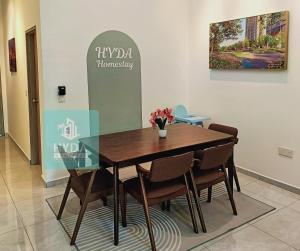 a dining room with a wooden table and chairs at HYDA Homestay Pool Melaka, Bandar Melaka in Melaka +6 photos
