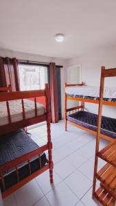 a room with two bunk beds and a window at Moradias Maestrelli in Guaratuba