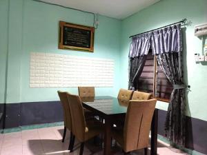 a dining room with a table and chairs at Super Fully Furnished House next to airport - peaceful, leisure and quite in Langkawi Intl