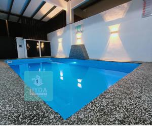 a swimming pool in the middle of a building at HYDA Homestay Pool Melaka, Bandar Melaka in Melaka