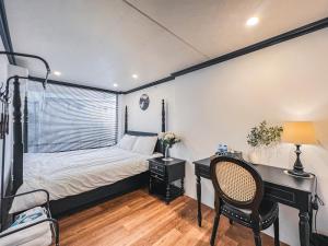 a bedroom with a bed and a desk and a desk at 2 Indochine Design Apartment - Hanoi Old Quarter in Hanoi +31 photos