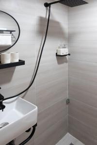 a bathroom with a sink and a shower at 2 Indochine Design Apartment - Hanoi Old Quarter in Hanoi
