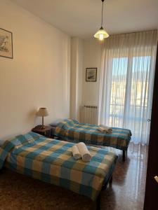 a room with two beds and a window at CA TEA in Lavagna