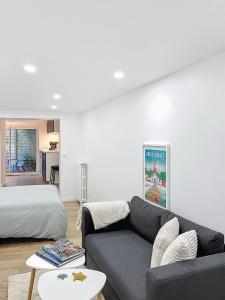 - un salon avec un canapé et un lit dans l'établissement Studio La Marne Paris, à Saint-Maur-des-Fossés
