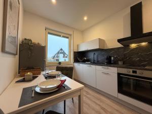 a kitchen with a table and a counter top at FeWo am Baunsberg in Baunatal
