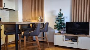 a living room with a table and a christmas tree at Apartman Grujanac in Zlatibor