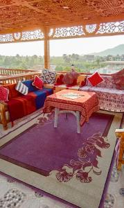 a living room with couches and a table and a rug at Akhenaten Apartments in Luxor