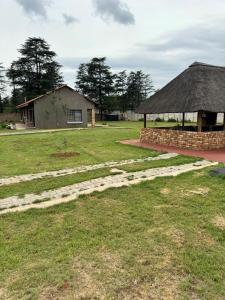 a yard with a building and a stone path at The Herby Taylor Guest House in Vereeniging