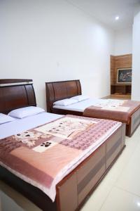 Postel nebo postele na pokoji v ubytování Khách sạn Bảo Lộc Garden