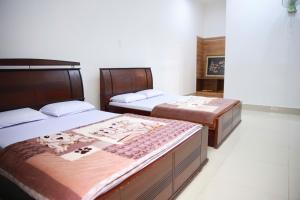 Postel nebo postele na pokoji v ubytování Khách sạn Bảo Lộc Garden