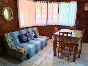 a living room with a couch and a table at Chalés do Atlântico Sc in Itapoa