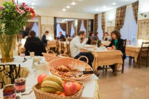 a table with baskets of fruit in a restaurant at Hôtel du Helder in Lyon