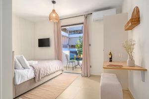a bedroom with a bed and a desk and a window at Fly & Stay in Artemida