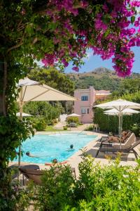 a swimming pool with umbrellas and people in it at Boutique Hotel Casa Mariantonia in Anacapri