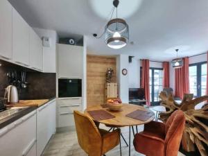 a kitchen with a table and chairs and a dining room at Appartement Flocon de Neige, au coeur de Saint-Gervais in Saint-Gervais-les-Bains +5 photos