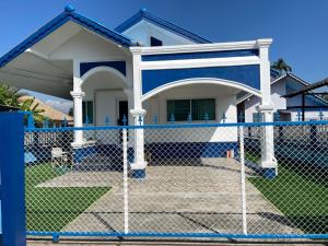 a fence in front of a house at Crypto Home in Ban Mae Mao