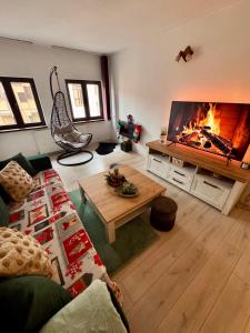 a living room with a large tv and a fireplace at Home central apartment Sibiu in Sibiu
