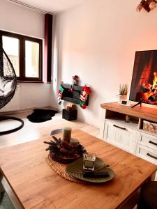 a living room with a table and a fireplace at Home central apartment Sibiu in Sibiu